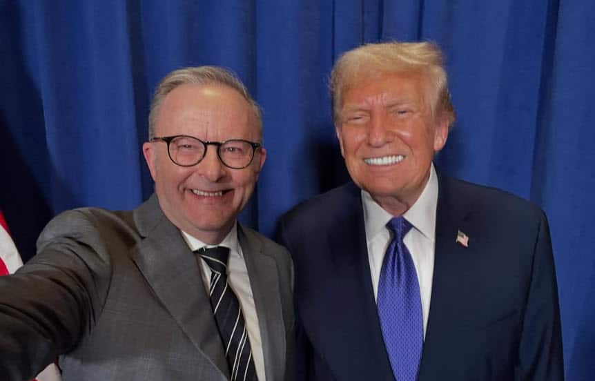 Two smiling men wearing suits