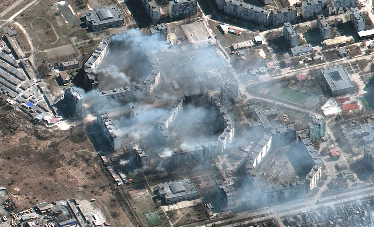 A Maxar satellite image of burning apartment buildings in Mariupol, Ukraine.