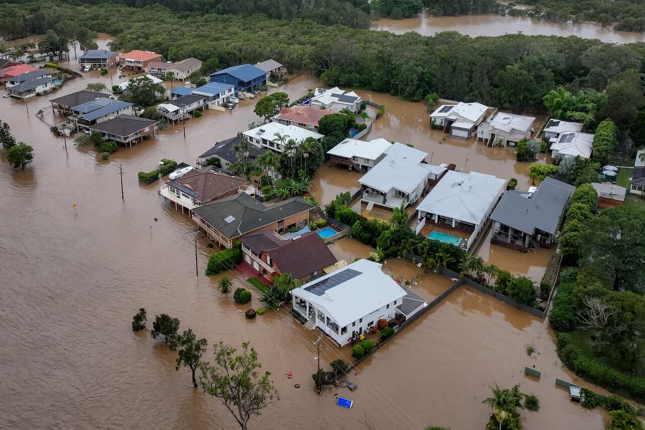Aerial view of brown floodwaters and houses 