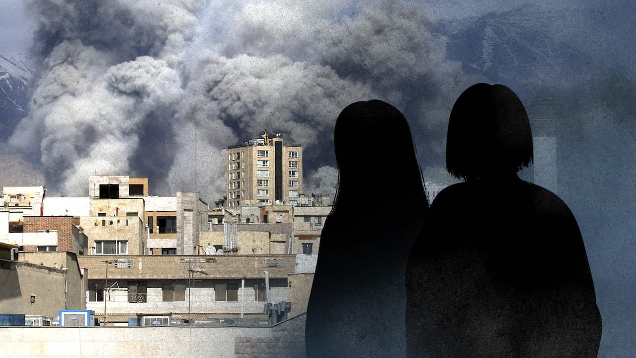 Smoke billows over city buildings in Iran, with two silhouetted figures in the foreground watching the scene.