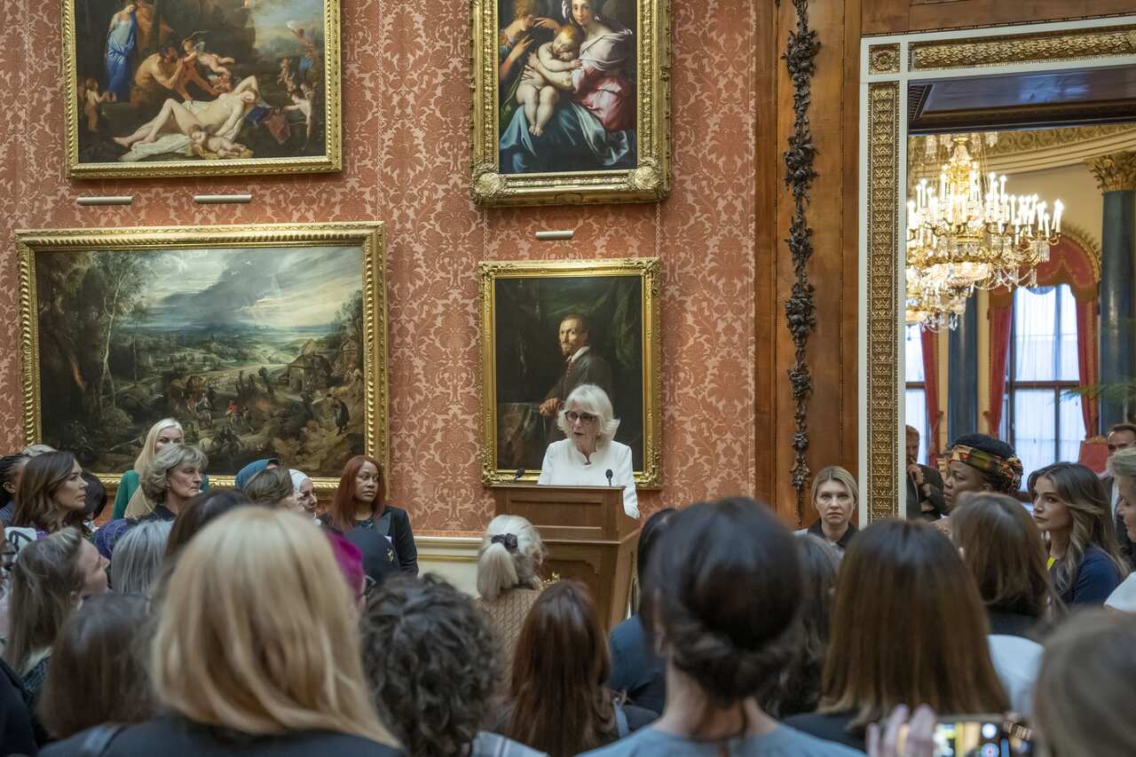 King Charles' wife Camilla speaks to a reception inside Buckingham Palace.