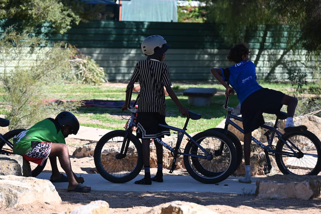 Children learn basic bike mechanics and road safety as part of the Bikes Mwerre program that creates a community of active children in Larapinta