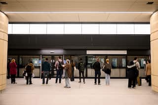 People waiting on a platform for a train.