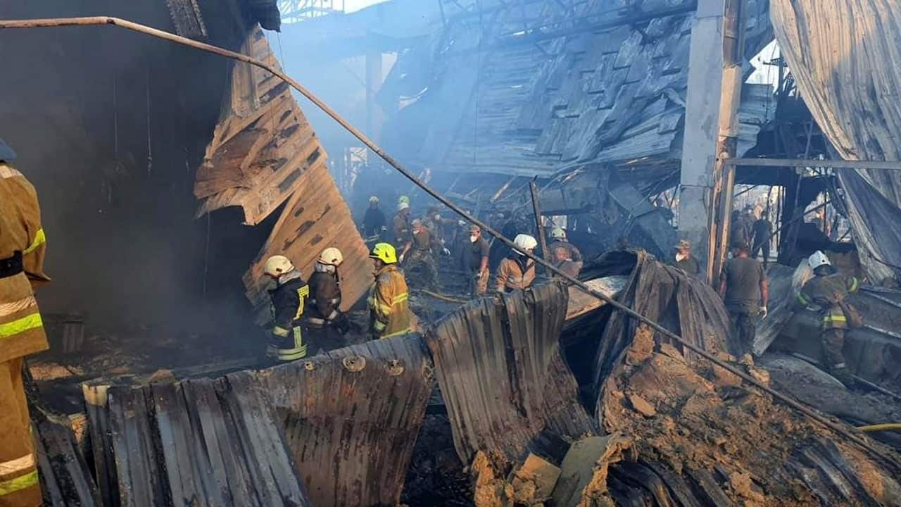 Firefighters and rescue services working to extinguish a fire at a shopping centre in Kremenchuk
