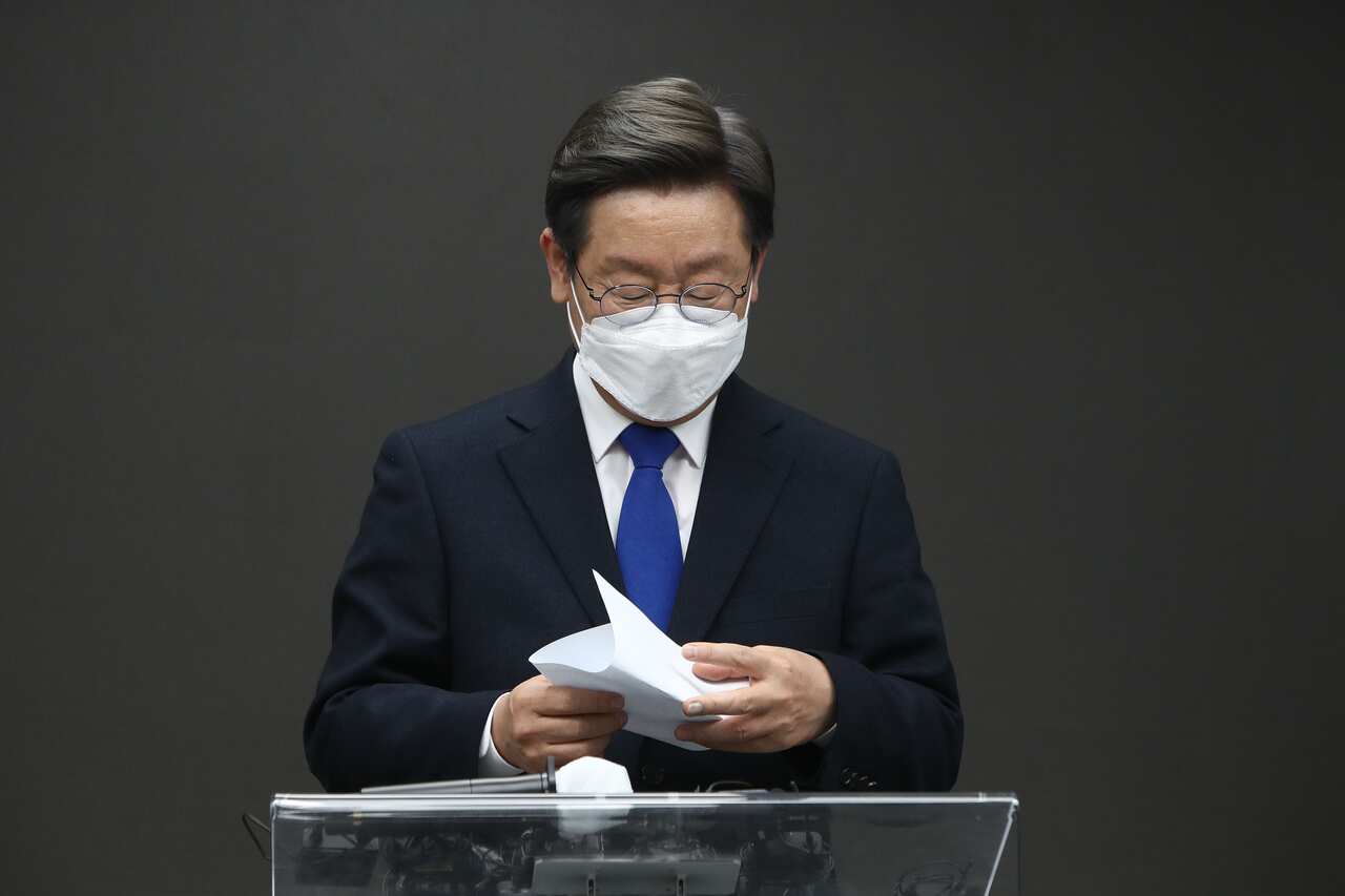 South Korean presidential candidate Lee Jae-myung of the Democratic Party is seen standing at a lectern.