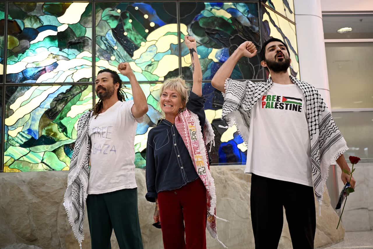 Global Sumud Flotilla activists Hamish Paterson, Juliet Lamont and Abu Bakr Rafiq arrive at Sydney Airport on Friday.