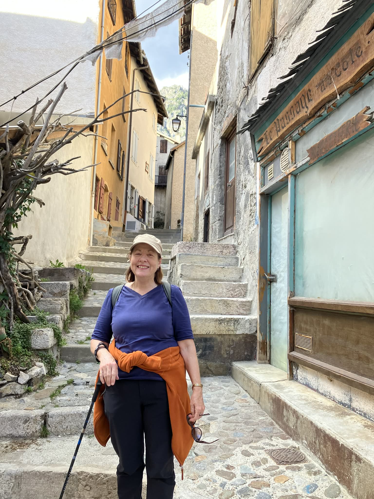 A woman wearing exercise gear on a cobblestone street. 