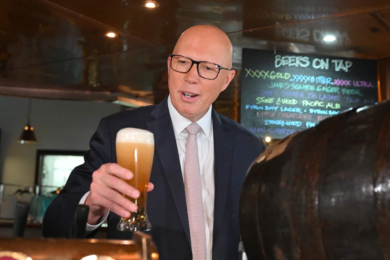 Peter Dutton holds a beer