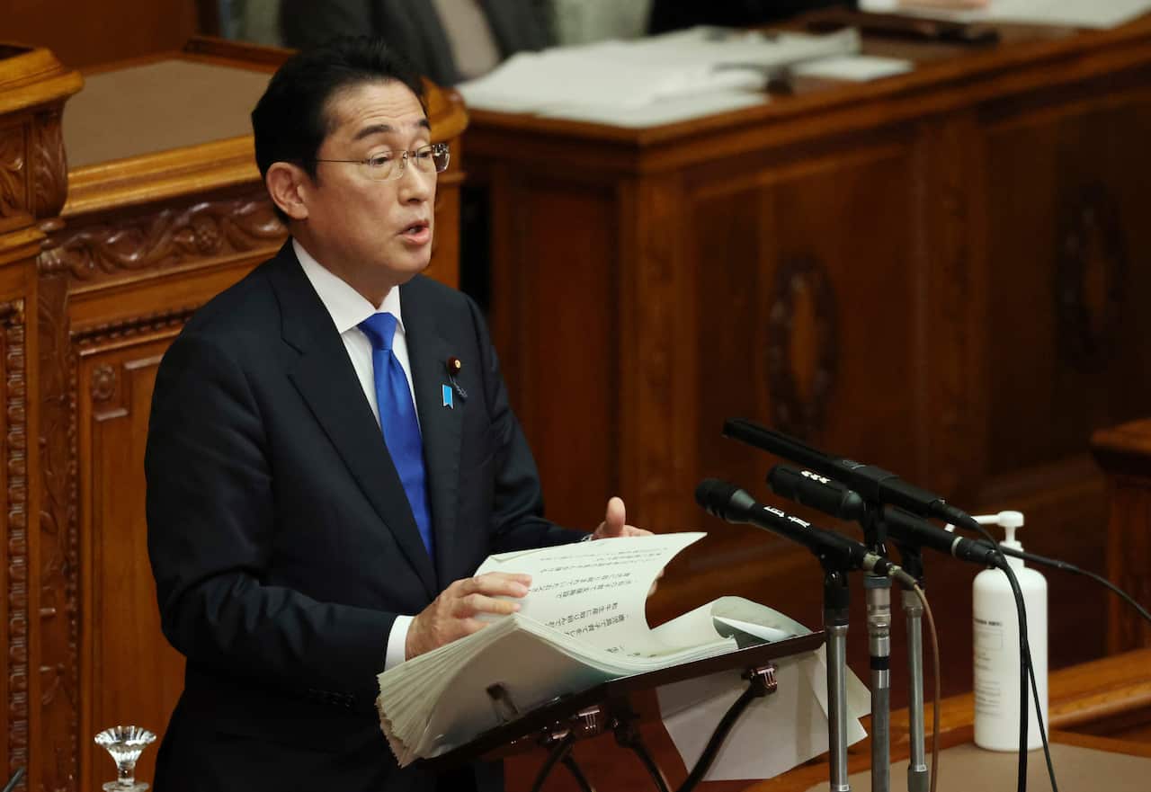 A man stands at a lectern and delivers a speech. 