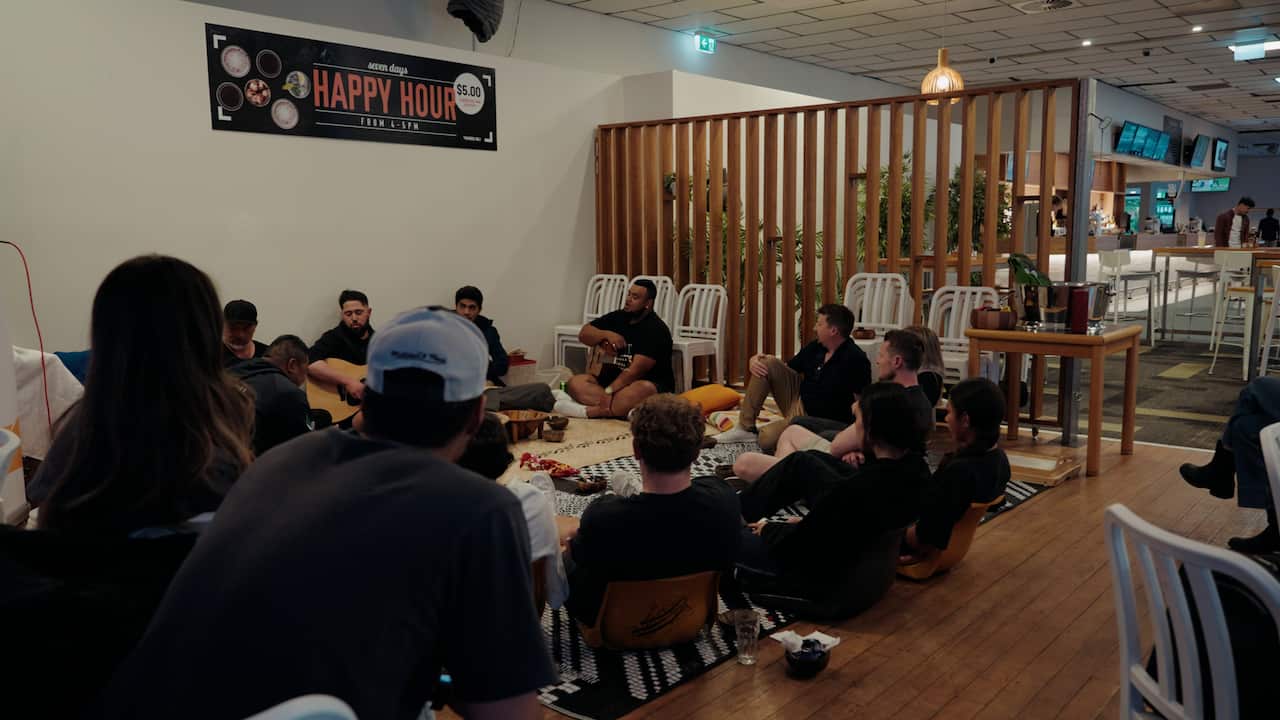 People sitting in a circle drinking kava.