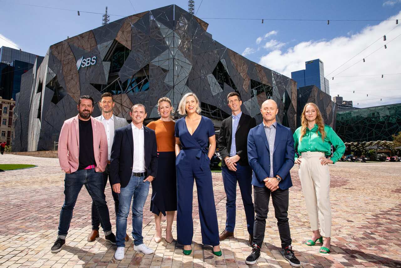 The SBS Cycling commentary team standing in front of the SBS building in Federation Square