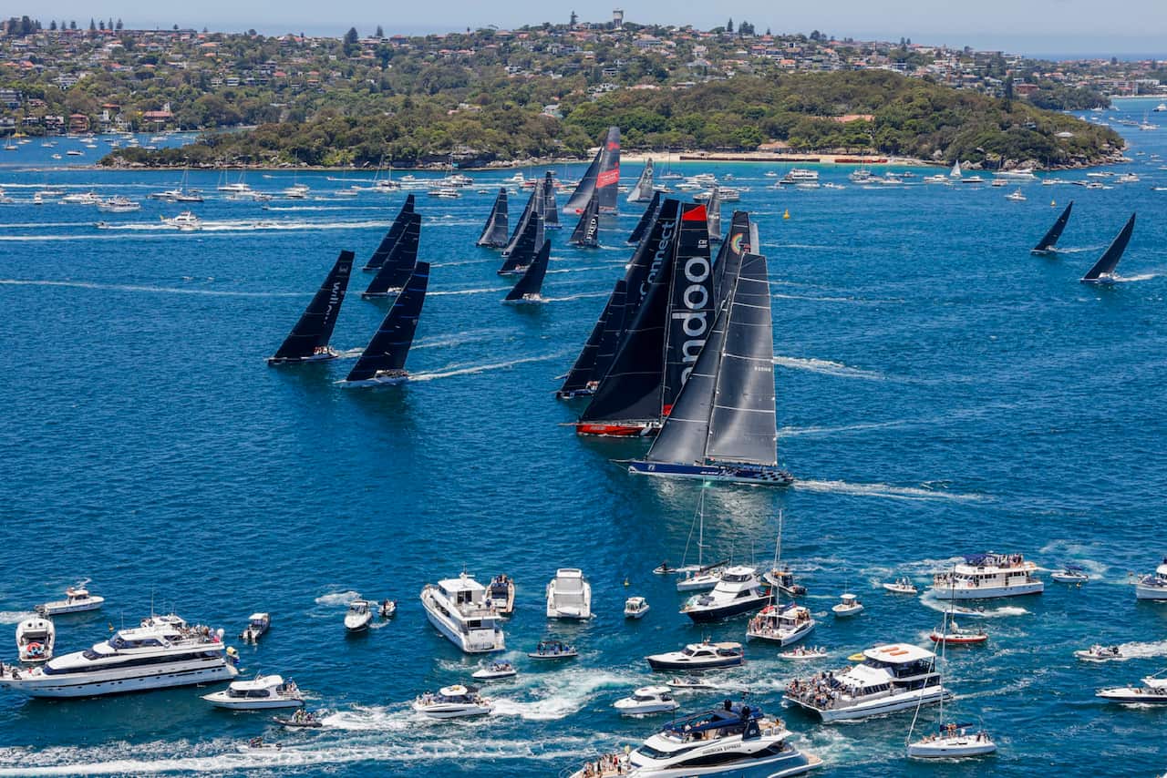 Boats race to the heads at the the start of the Sydney Hobart yacht race on Sydney Harbour.