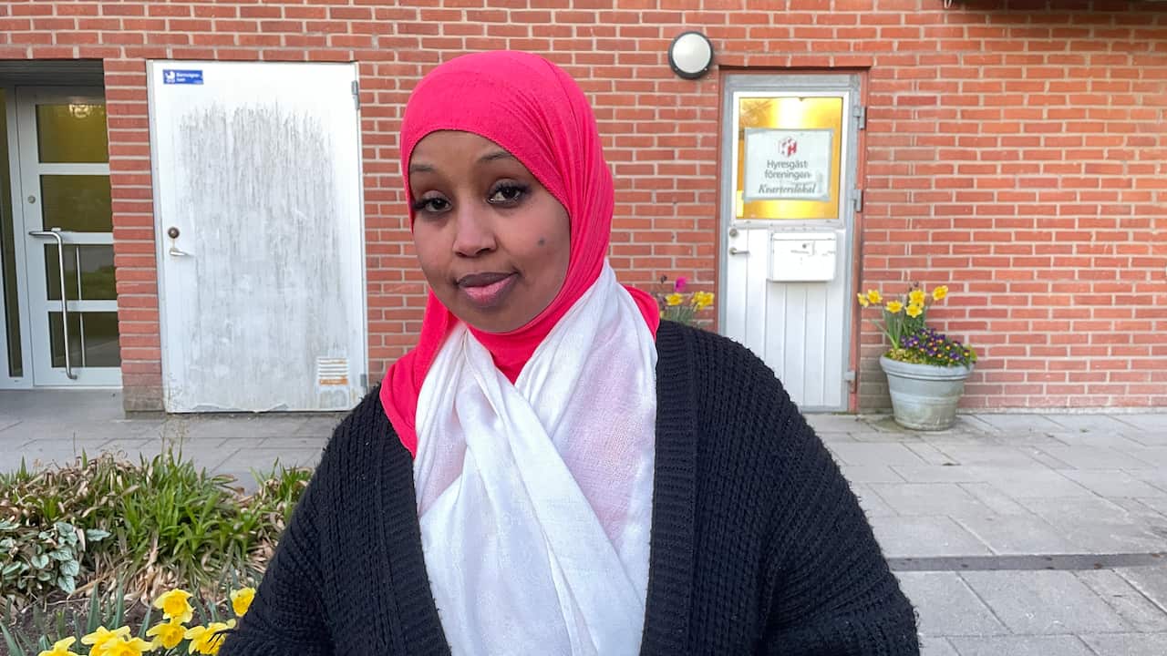 A woman wearing a pink hijab.