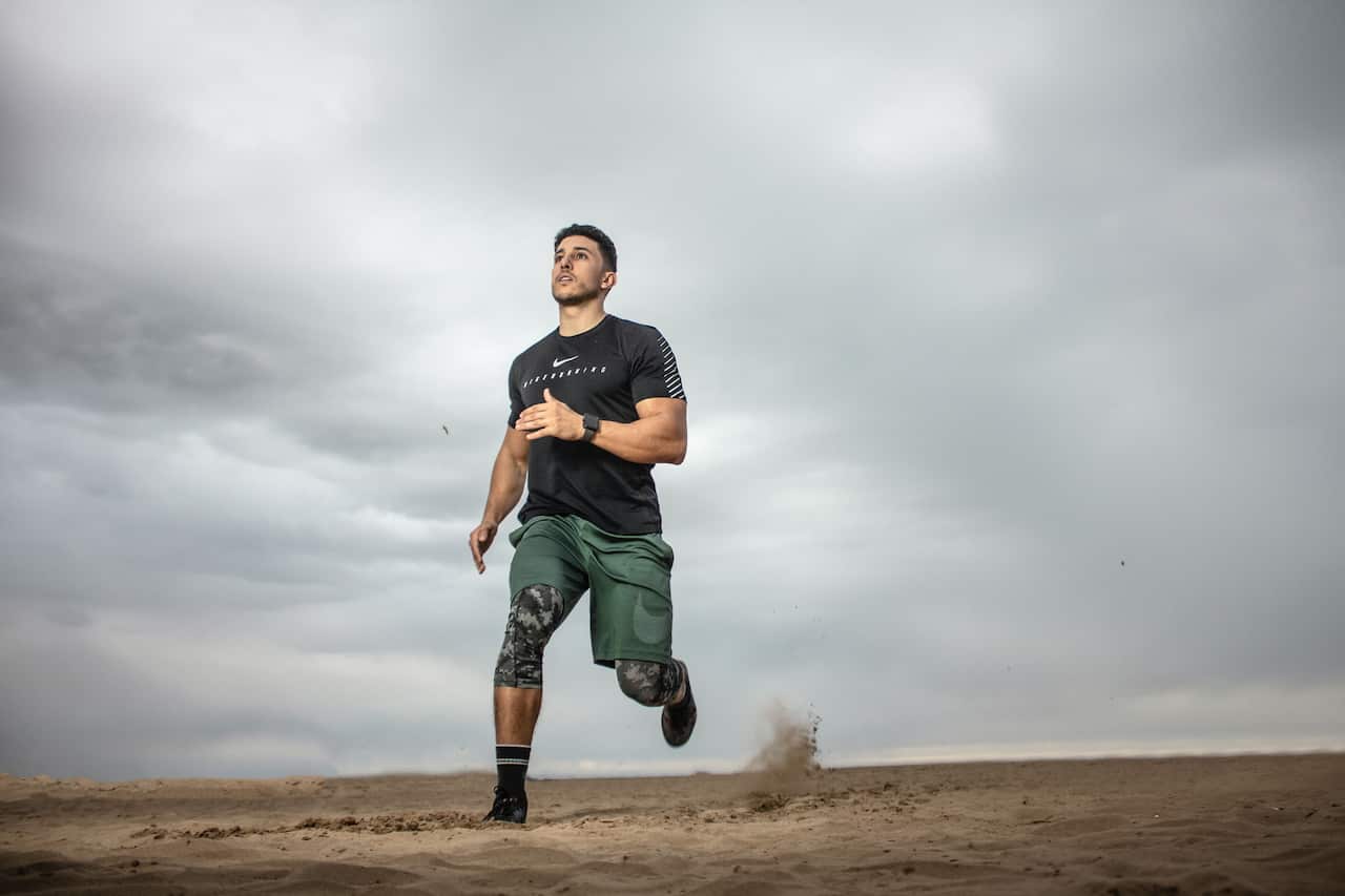 Exercise-Man running on sand field-pexels-zakaria-boumliha.jpg