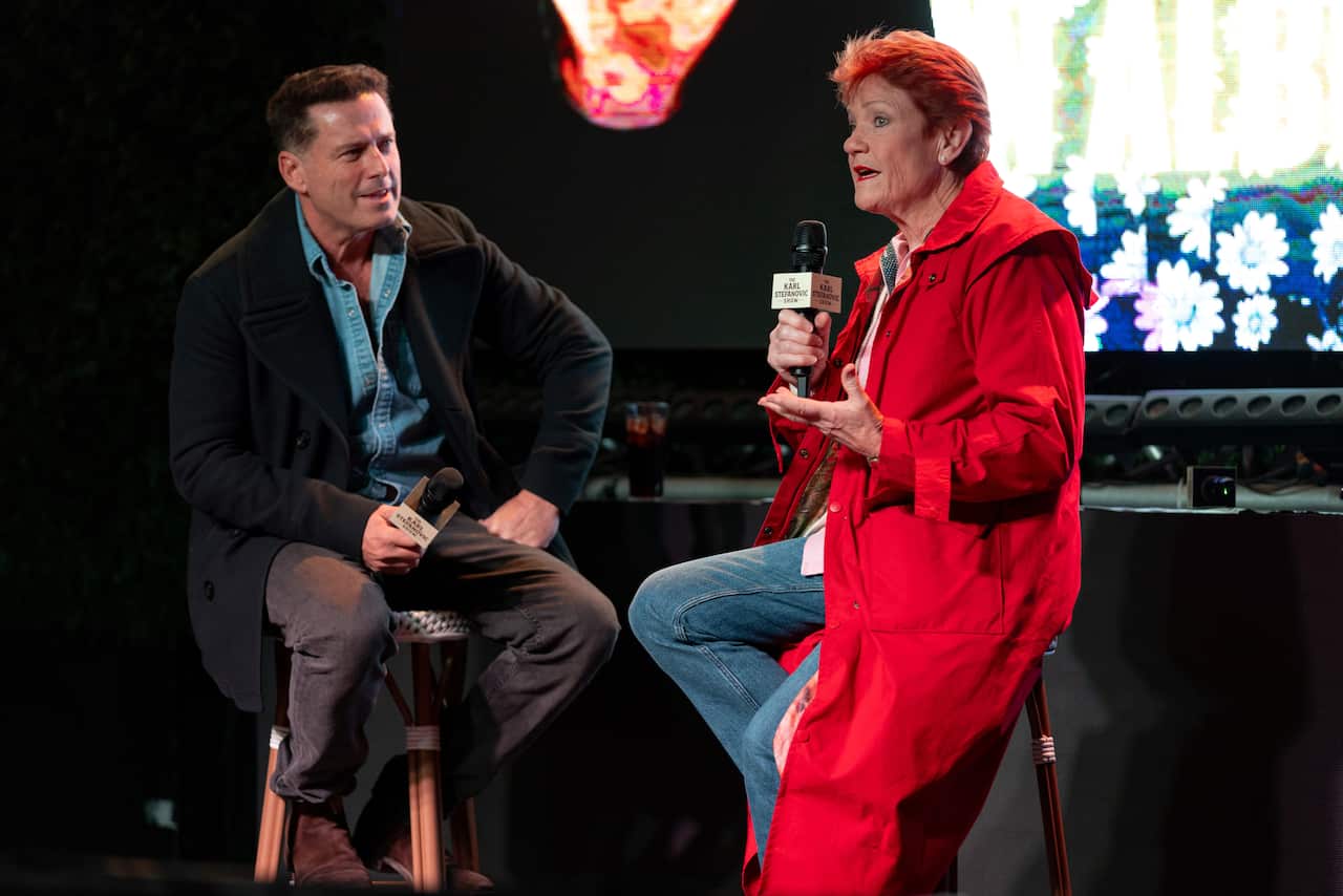 Karl Stefanovic stiting on a chair next to Pauline Hanson, who is also sitting on a chair and speaking into a microphone.