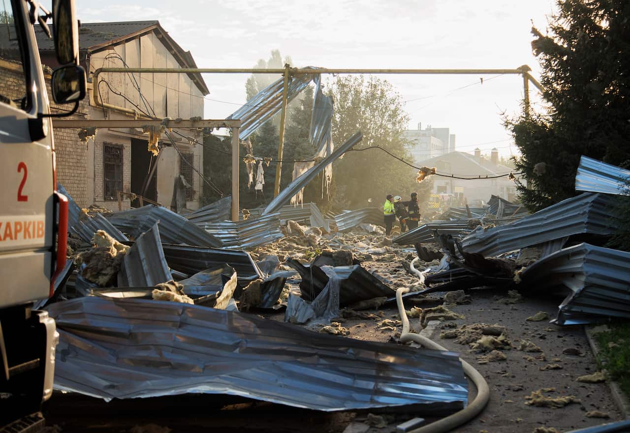 Metal sheeting and debris strewn over a road.