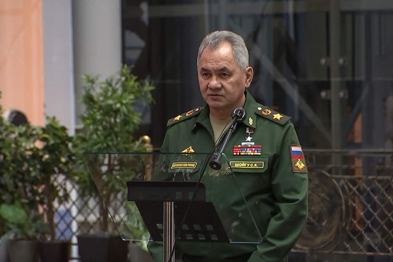 A man speaking while standing at a podium.