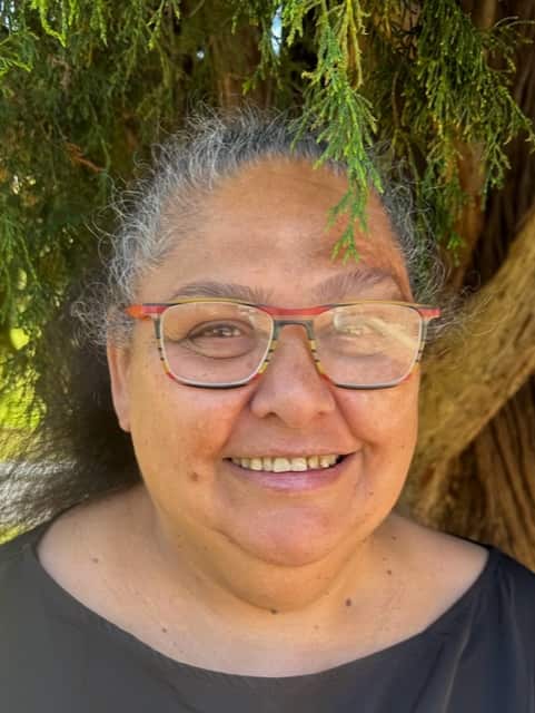 A portrait of a woman who is smiling.