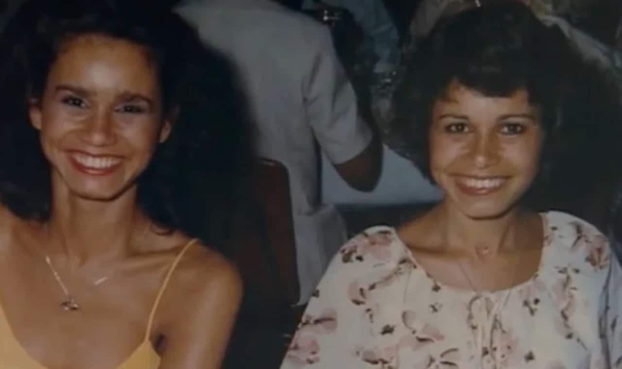 A photograph featuring two people smiling.