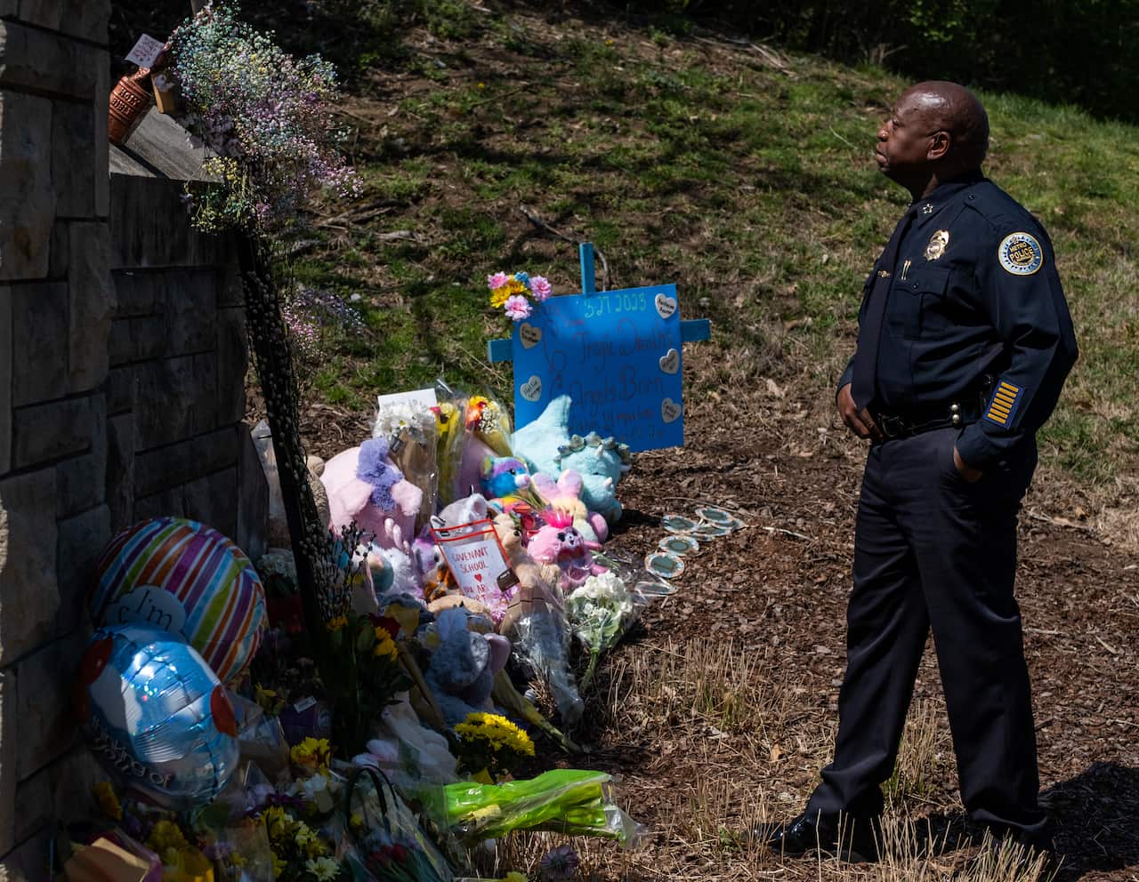 Chief of Police John Drake stands in front of memorial items left at the entrance of a Christian school in Nashville, Tennessee.