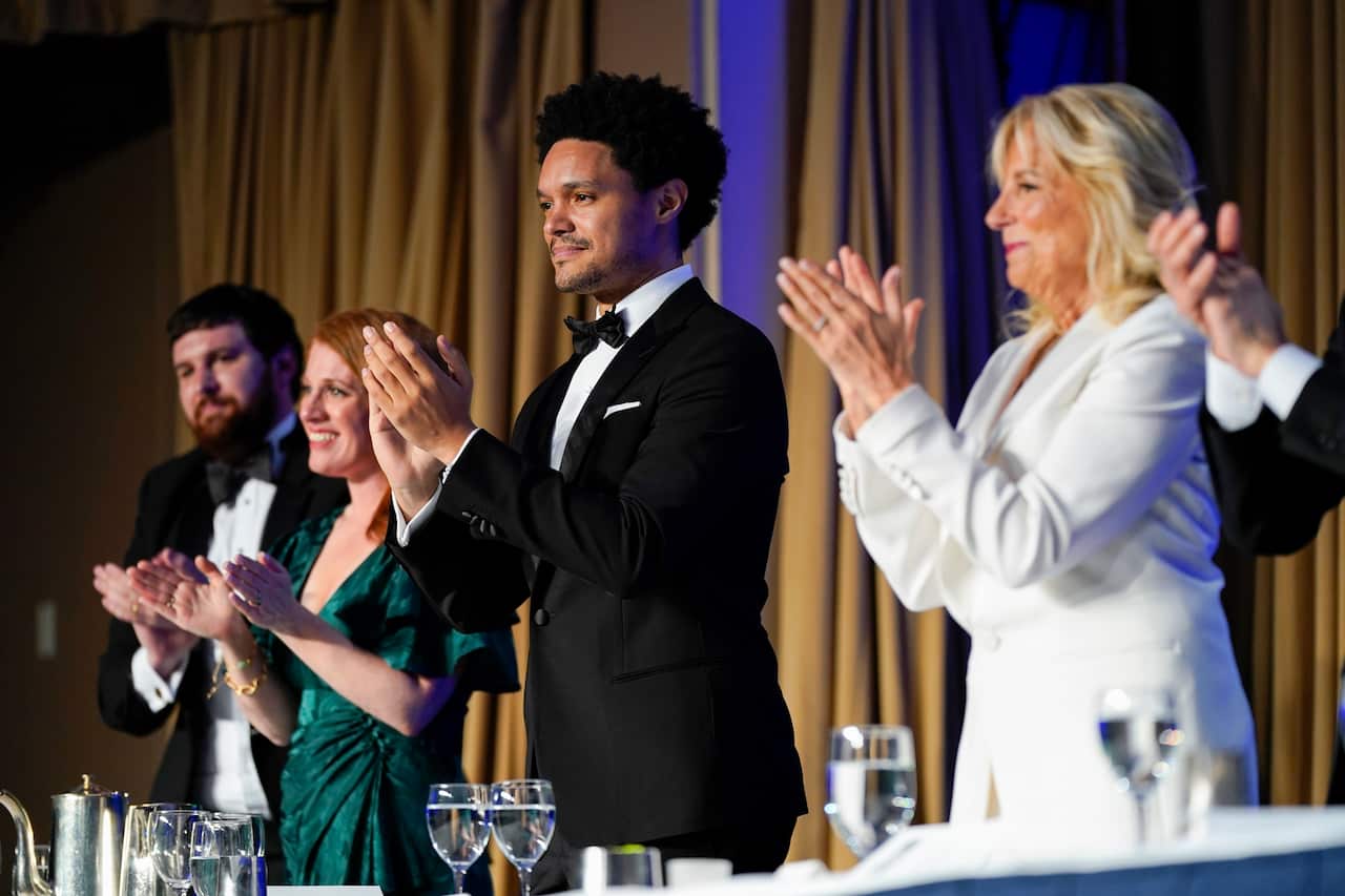 Trevor Noah (c), host of the Comedy Central's The Daily Show, applauds alongside first lady Jill Biden (c) at the annual White House Correspondents' Association dinner.