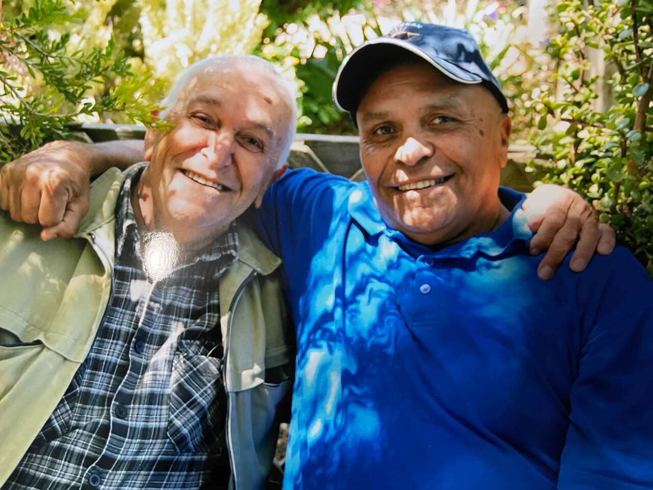 Two men with their arms around each other