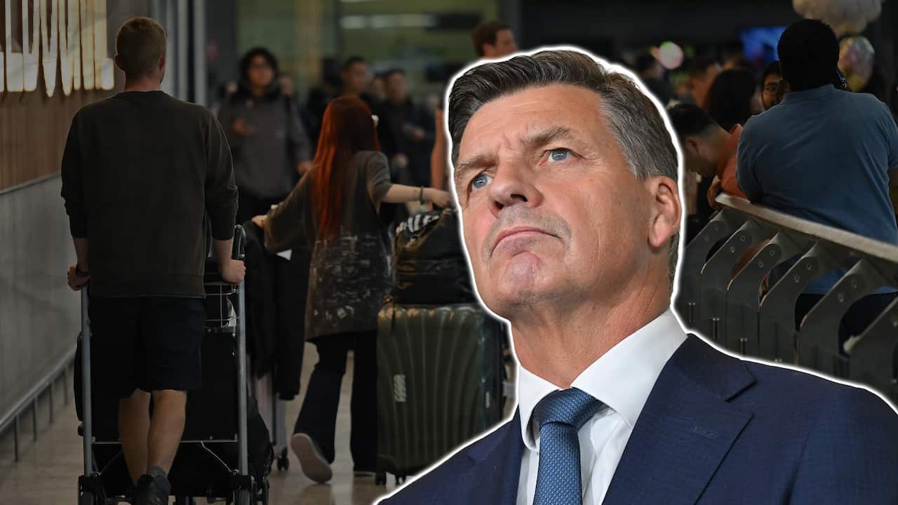 A cut out of Angus Taylor against people in an airport.