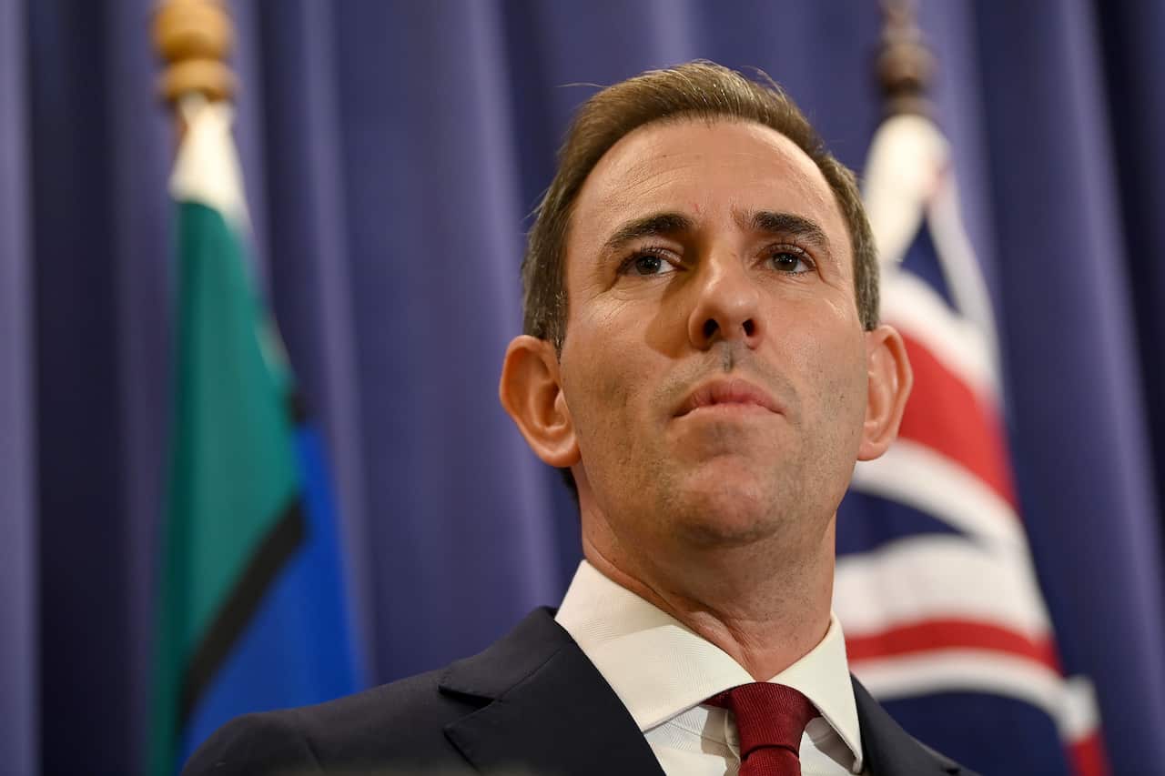 Low angle shot of Jim Chalmers addressing media. 