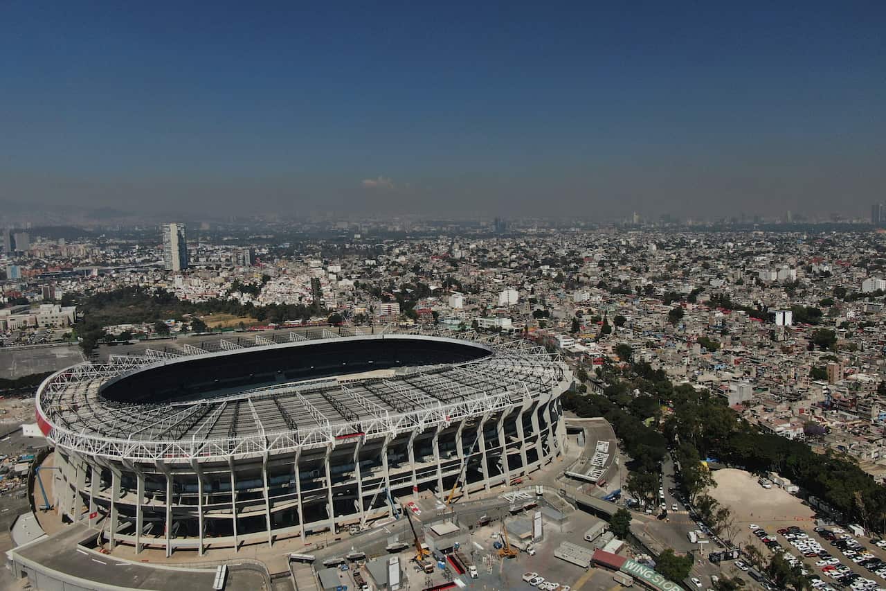 Aerial view of a large football stadium in a sprawling city
