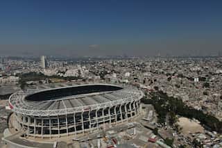 Aerial view of a large football stadium in a sprawling city