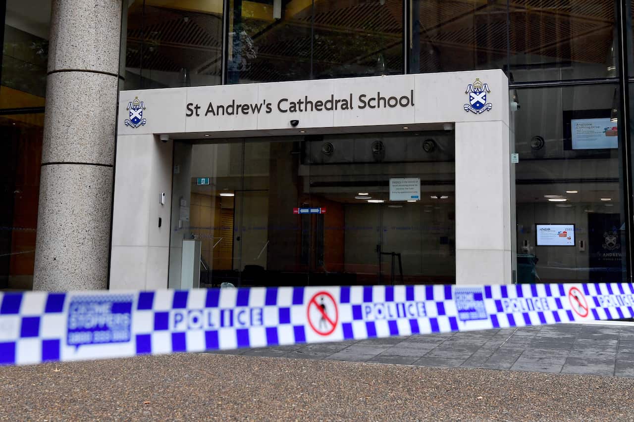 Police tape shown outside a school building.