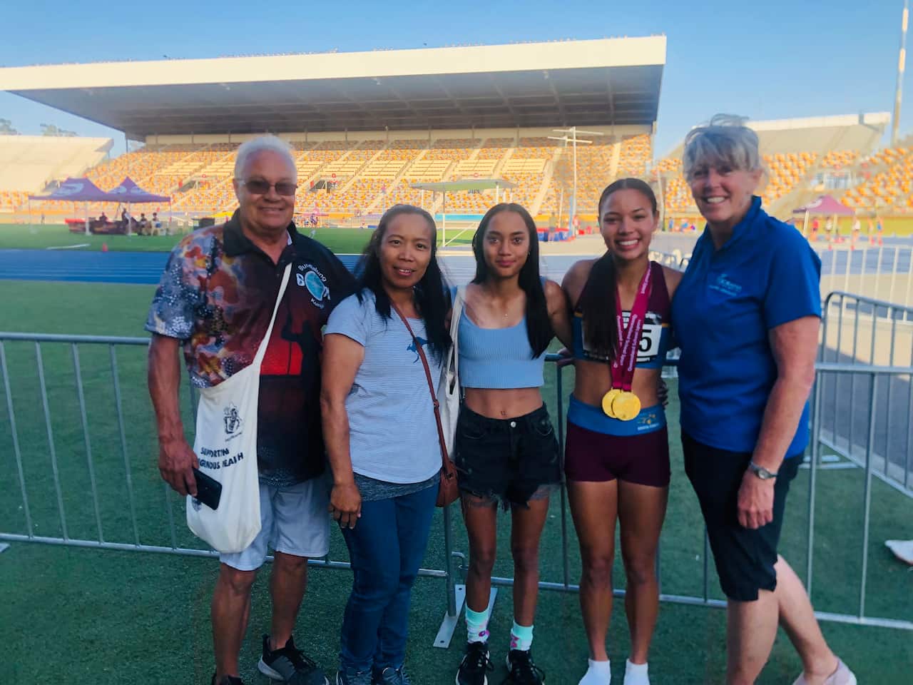 THEWBELLE PHILP WITH FAMILY AND COACH.jpeg