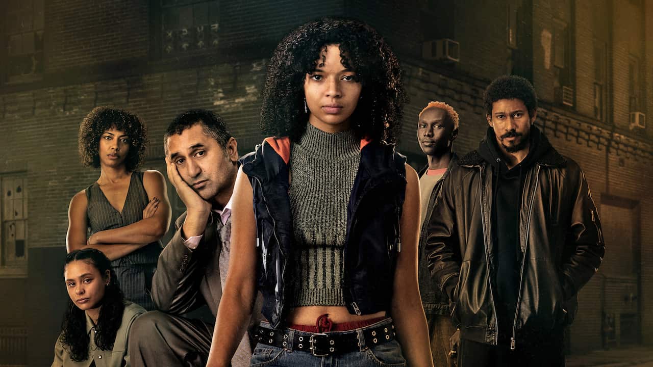 A composite image shows six people in front of a brick building. The young woman in the centre of the image stares ahead with a direct and confident gaze. 