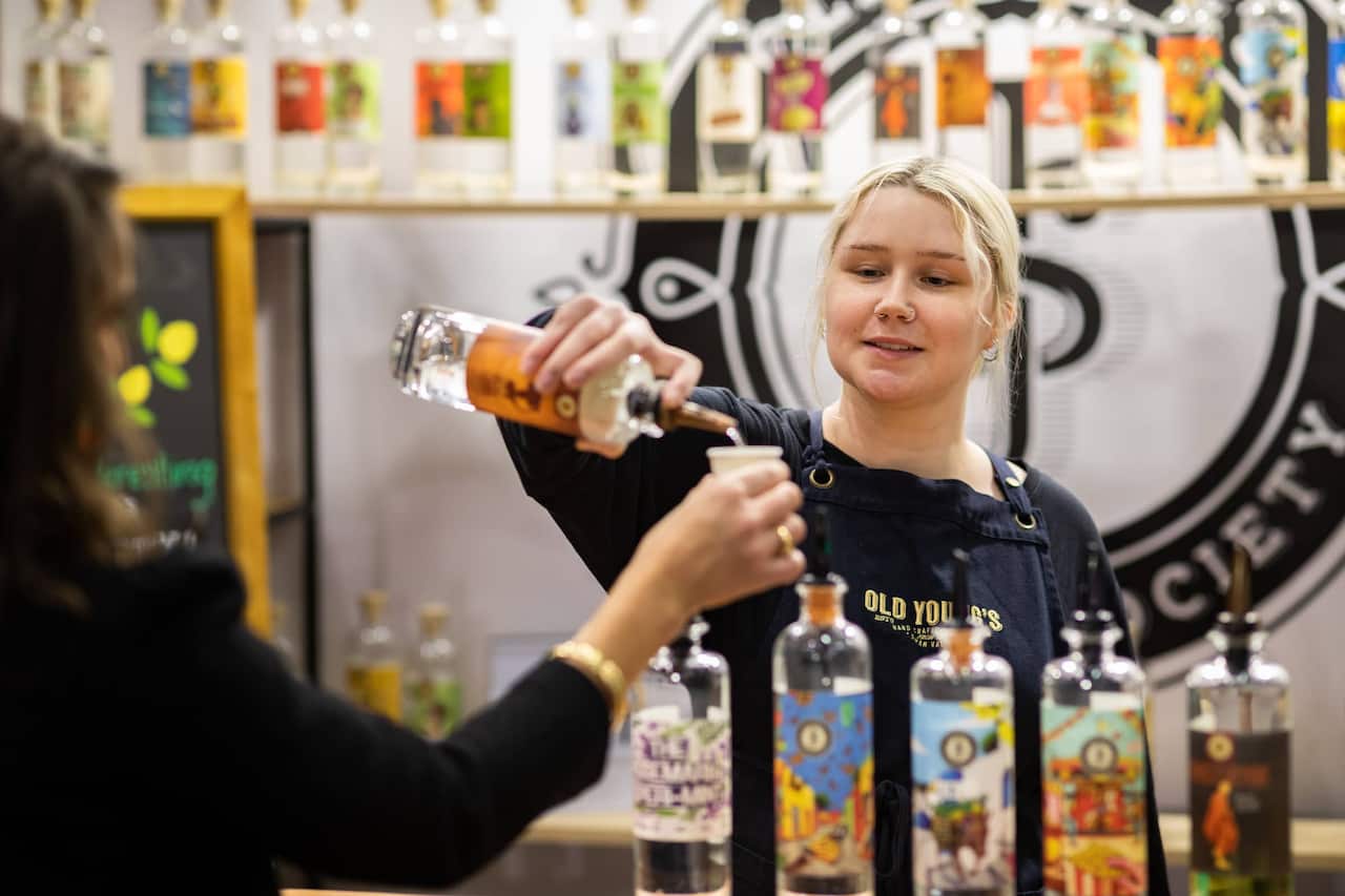 Staff member pouring a shot for a customer