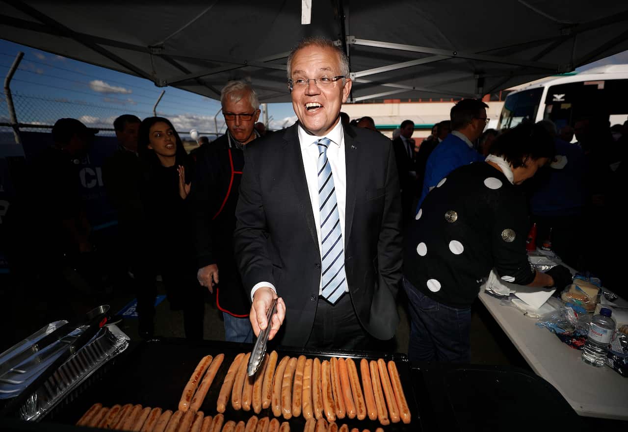 Man barbecues sausages. 