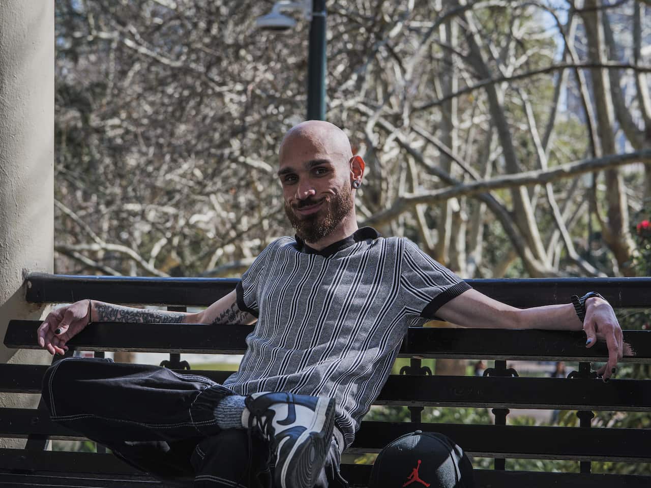 A man sits on a park bench.
