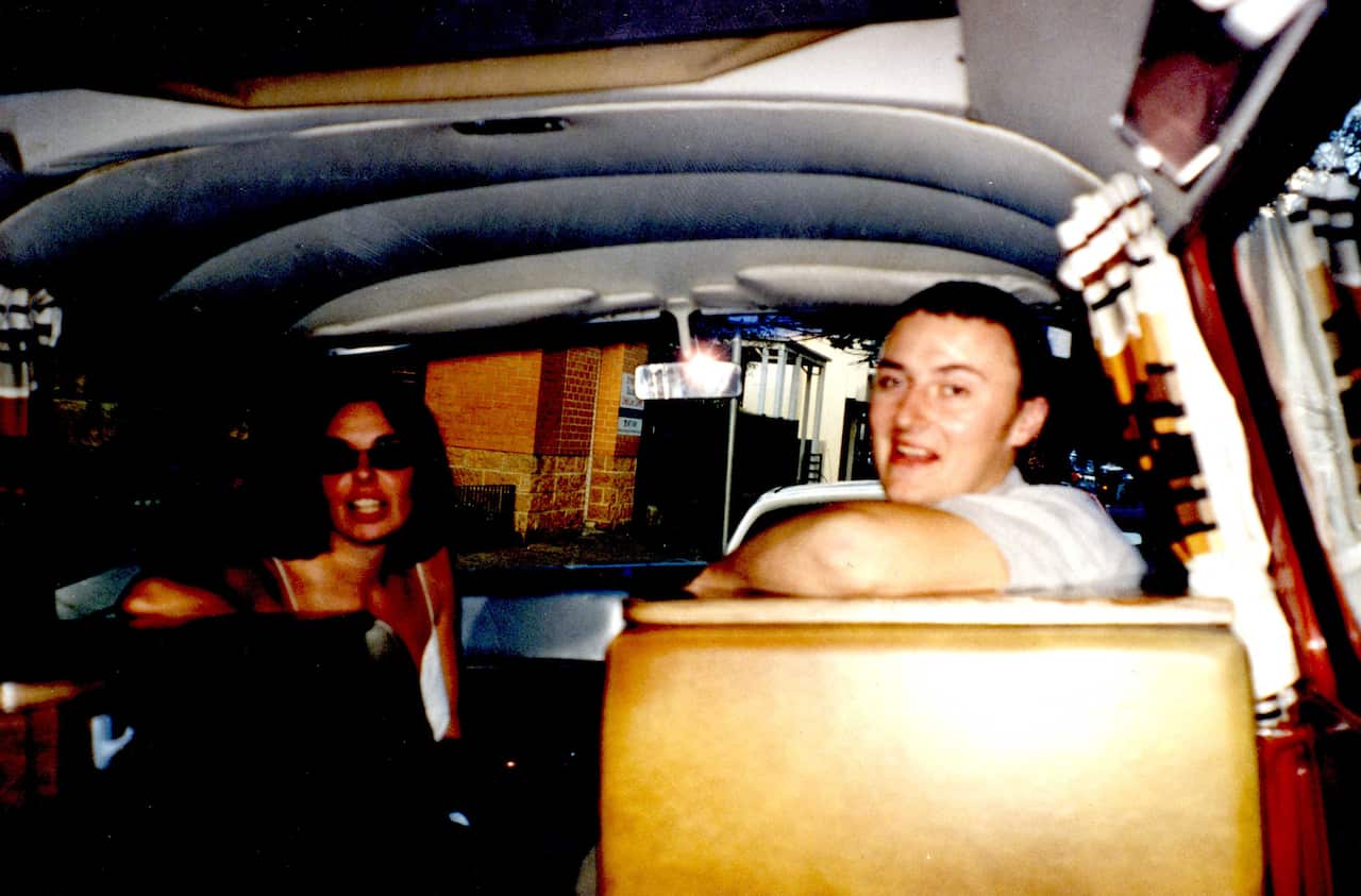 A young man and woman in a campervan.