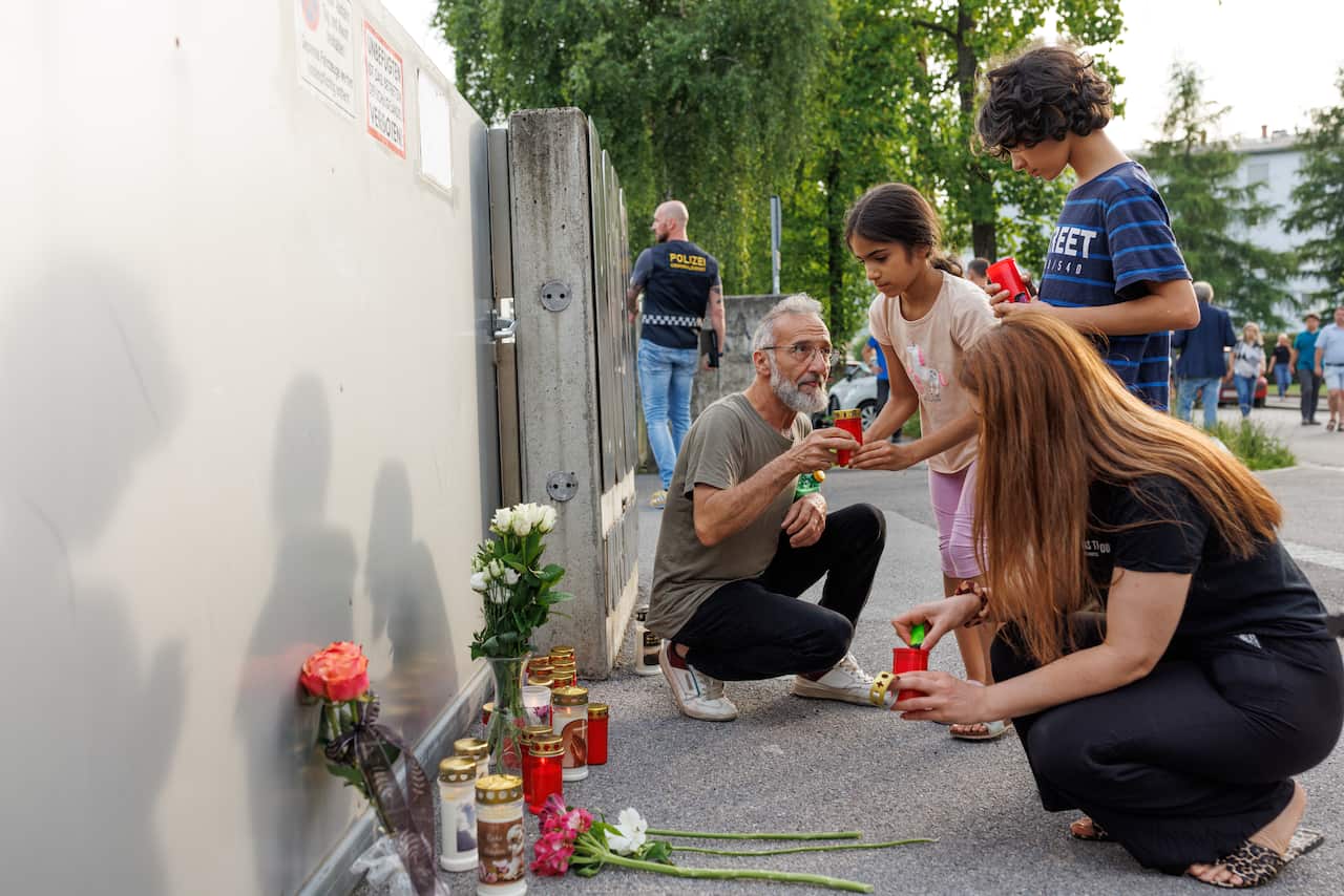 People leave flowers at scene of shooting