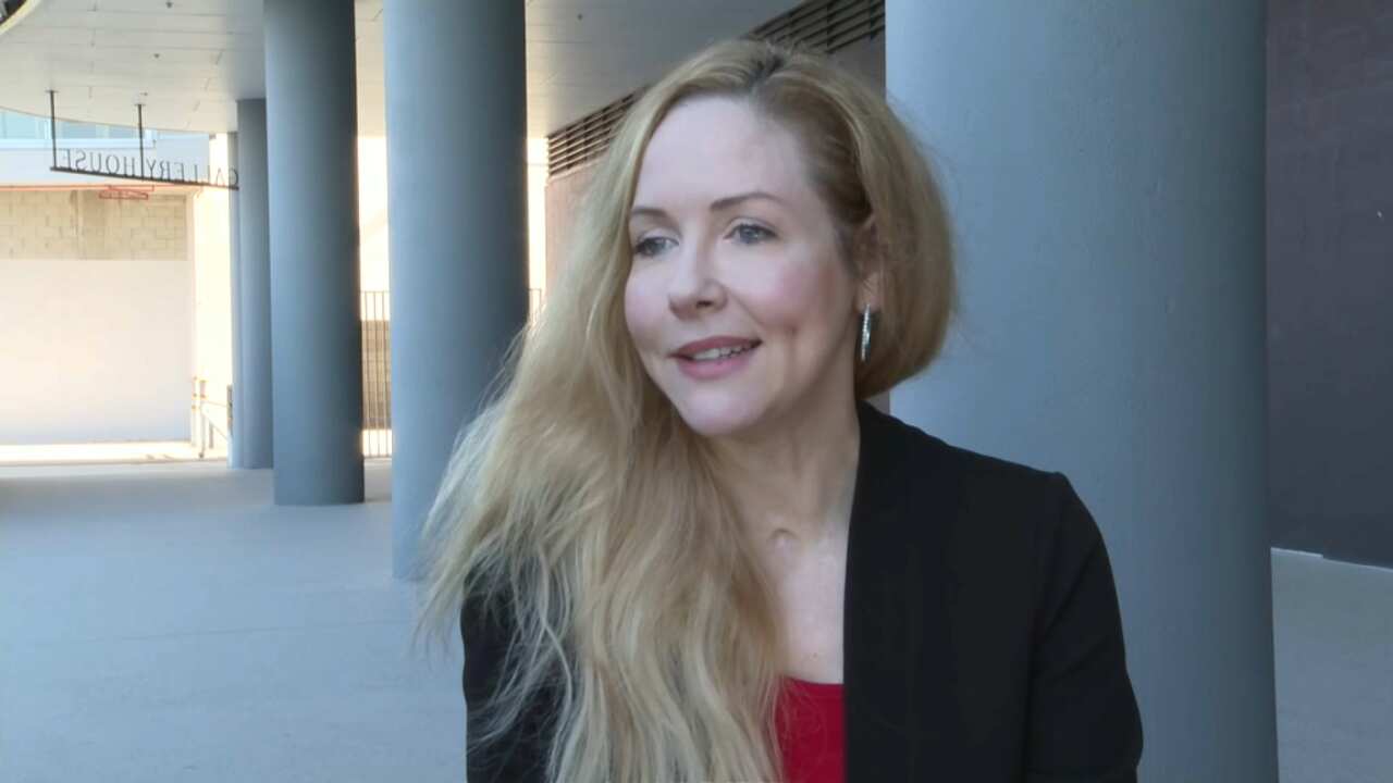 A woman with blonde hair wearing a black blazer.