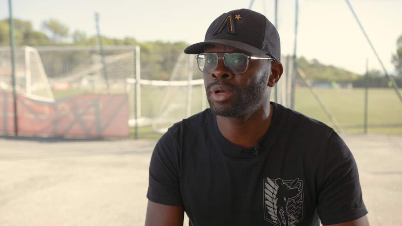 A man wearing glasses and a hat.