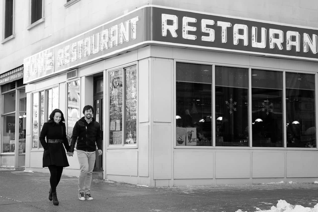 A black and white image of a couple holding hands