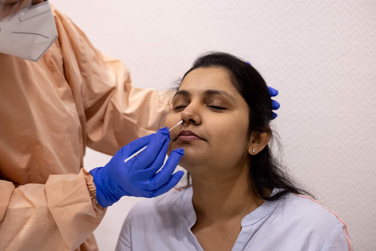 Woman undergoing a coronavirus test via her nose