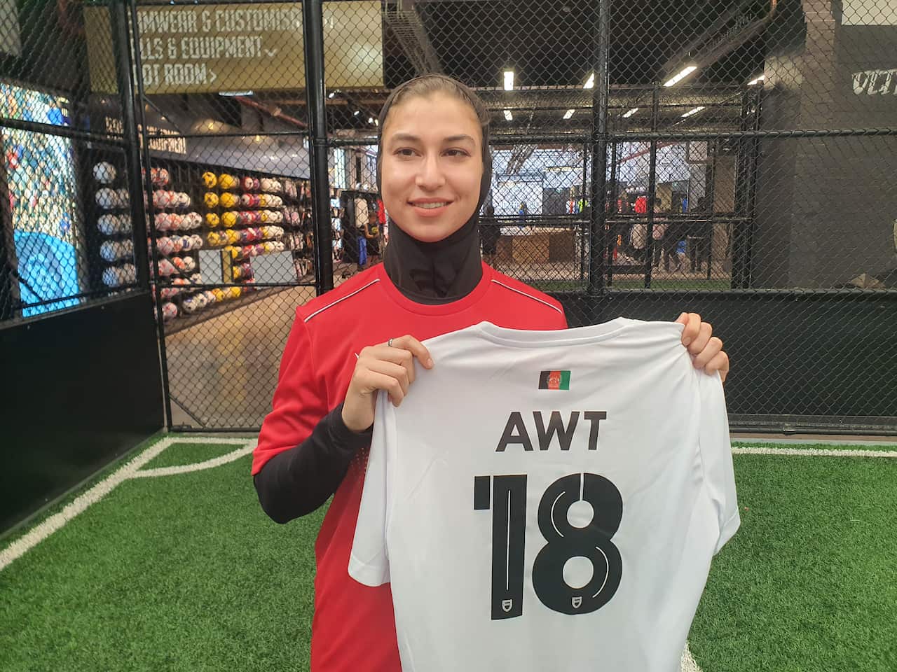 Footballer holding up her shirt. 