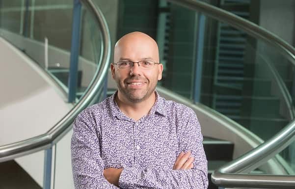 A man standing with his arms folded.