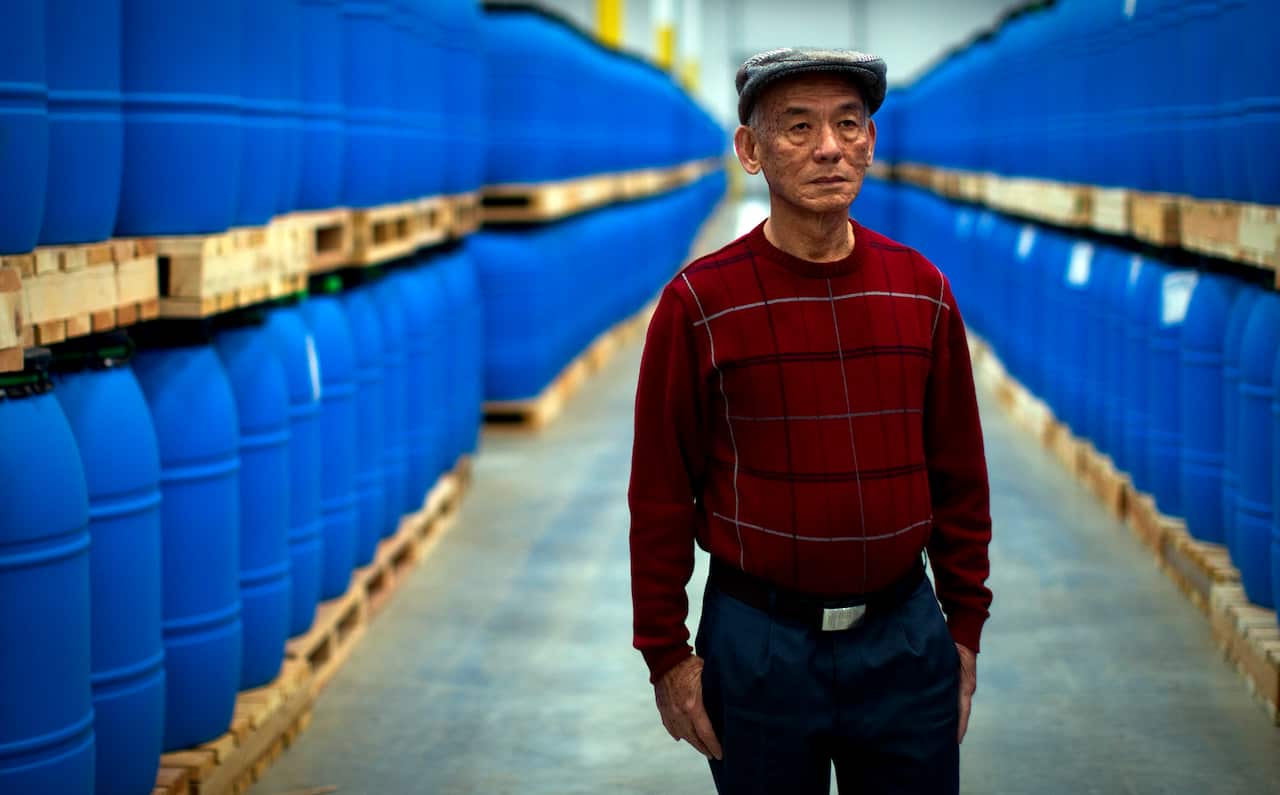 Man stands in a factory. 