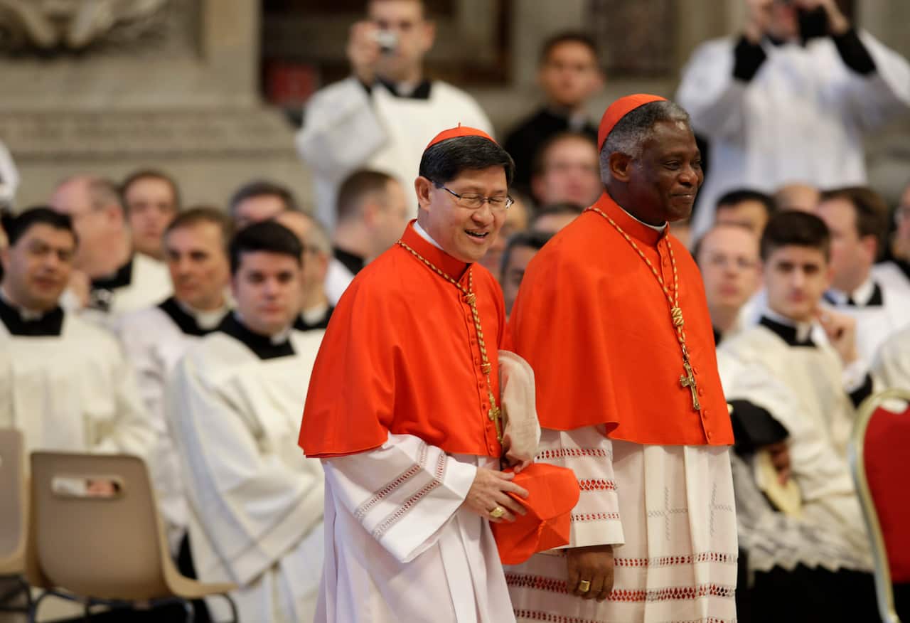 FILE - Cardinals Luis Antonio Tagle, of the Philippines, left, and Peter Kodwo Appiah Turkson, of Ghana, are among the popular names as possible contenders for the Papacy
