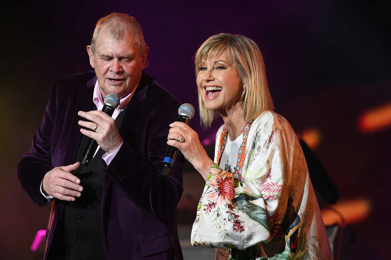 John Farnham (left) and Olivia Newton-John (right) singing together