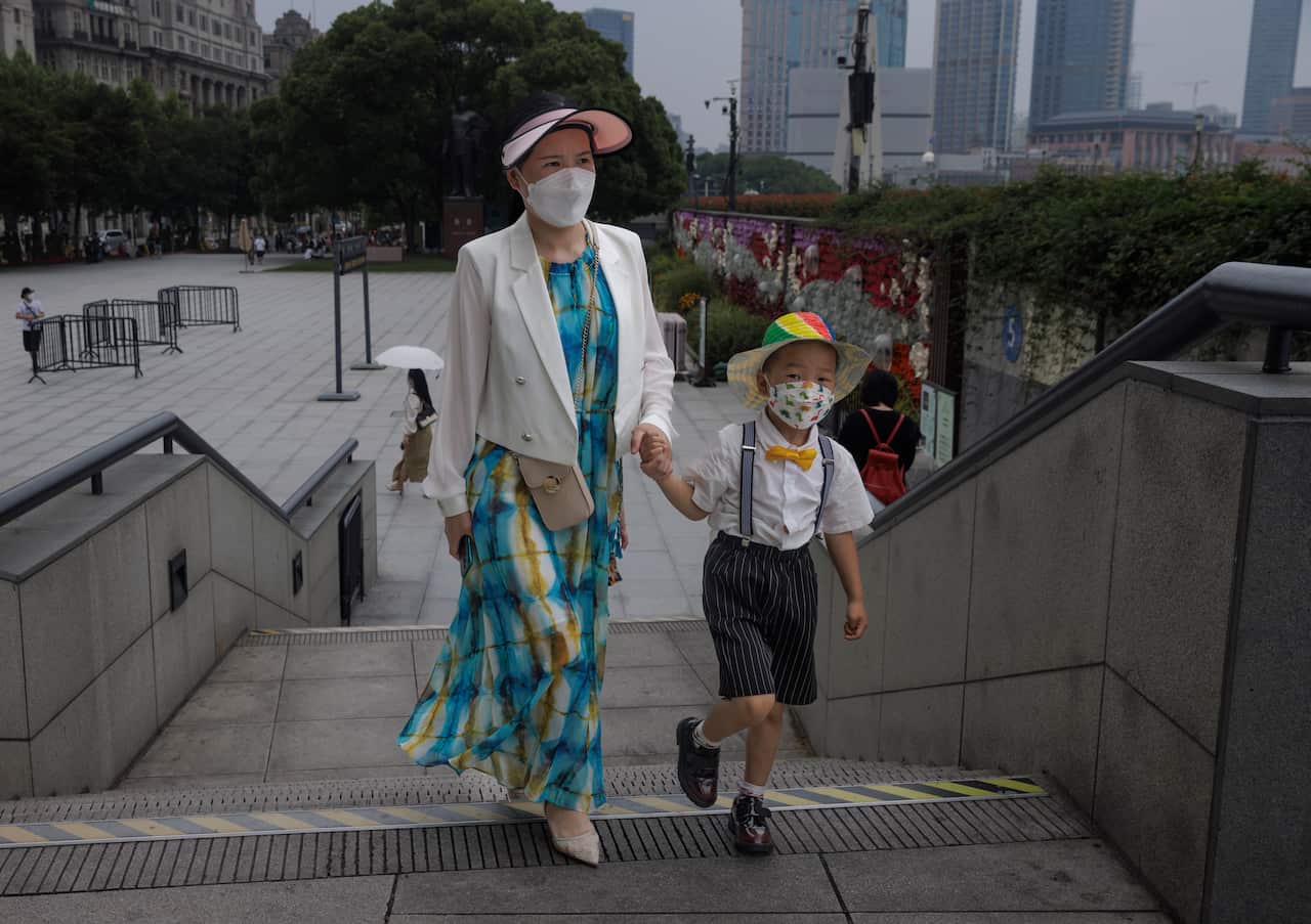 A mother and child walk up stairs in Shanghai