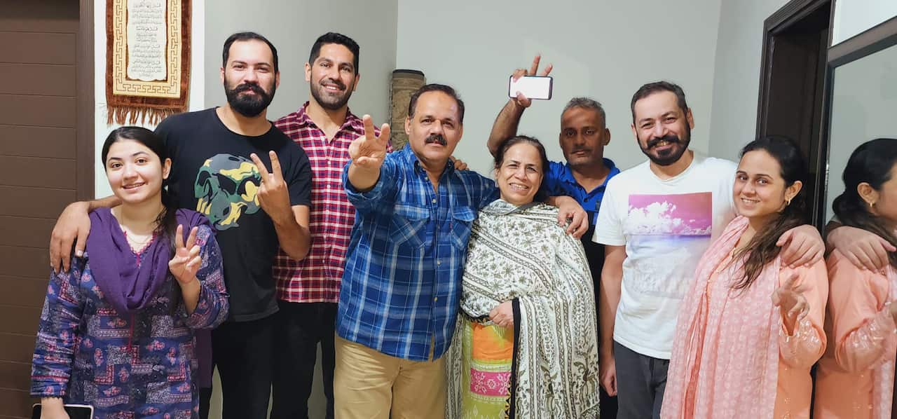Taufiq Rind (Third from left) with family members and peers. 