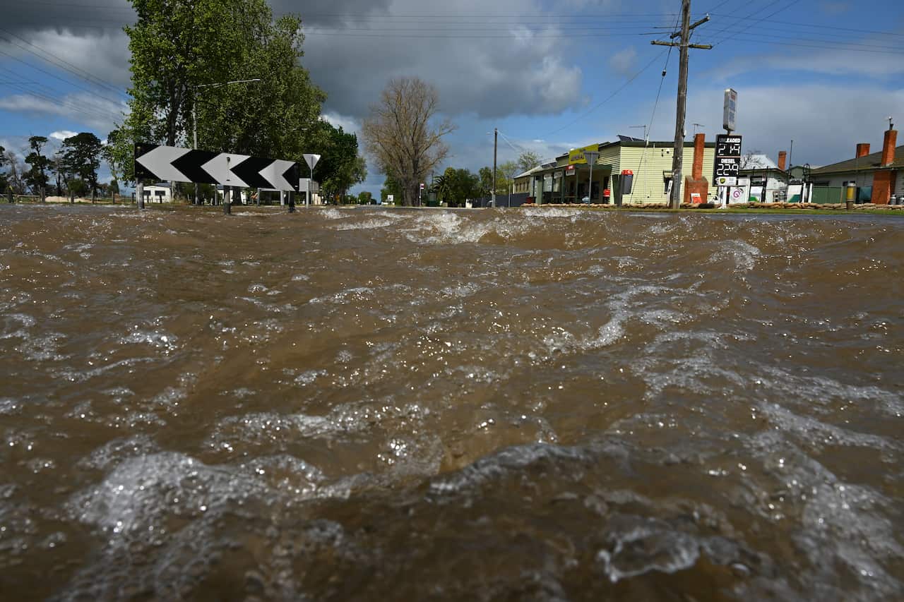 Flood water is seen opposite a general store.